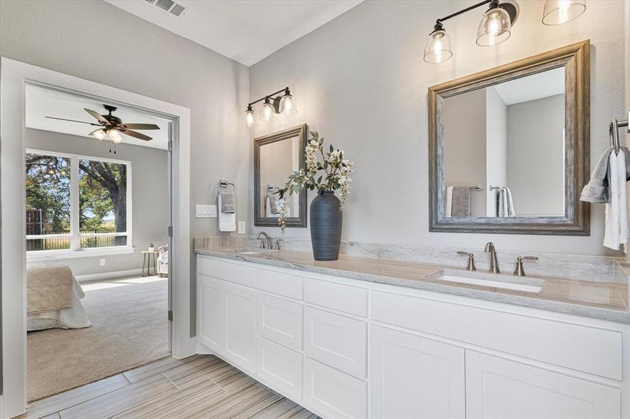 Bathroom featuring ceiling fan, tile patterned floors, and vanity