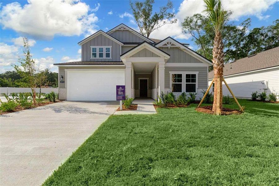 Front exterior of a new home in The Cypress Series at Reserve East, Flagler Beach, FL, highlighting curb appeal (Image 1).