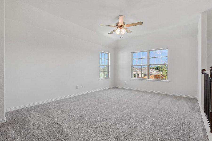 Spare room with carpet and ceiling fan