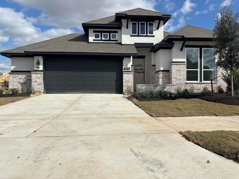 Front exterior of a new home in Bridgeland 55', Cypress, TX, highlighting curb appeal (Image 1). Front exterior of a new home in Bridgeland 55', Cypress, TX, highlighting curb appeal (Image 1).