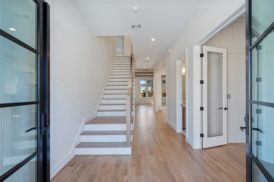 Beautiful double door entry into home with white oak hardwoods throughout