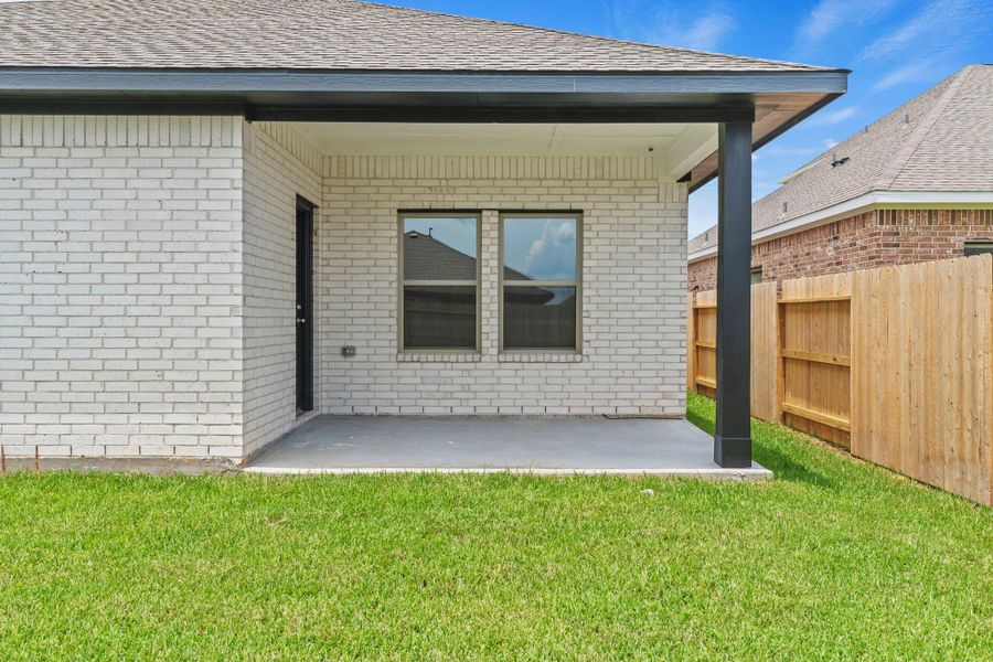Exterior details and patio area of a home in Windrose Green, Angleton (Image 15).