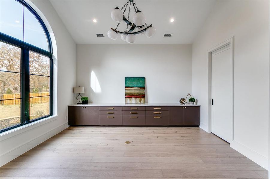 Handsome, large study with built in cabinetry, beautiful arched window, views outside and through the double sided fireplace just outside the room. A spacious closet allows room for supplies, printer and more. Handsome, large study with built in cabinetry, beautiful arched window, views outside and through the double sided fireplace just outside the room. A spacious closet allows room for supplies, printer and more.