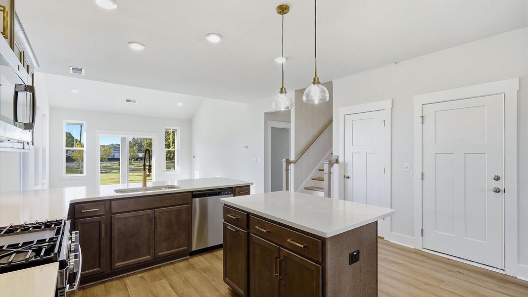 Exclusive kitchen design with center island, pendant lights, and tasteful finishes throughout at Barton Hollow Exclusive kitchen design with center island, pendant lights, and tasteful finishes throughout at Barton Hollow