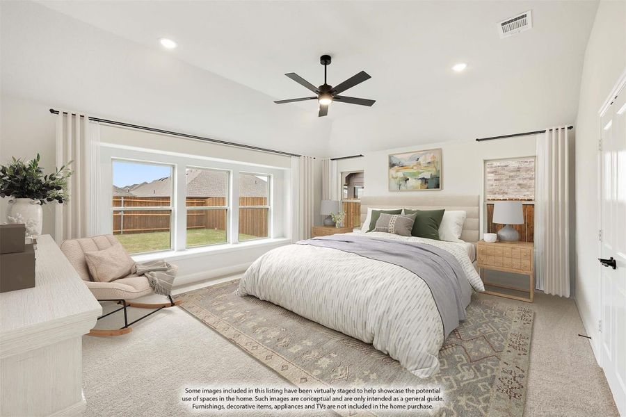 Spacious master bedroom with ceiling fan, large windows, carpet flooring, and neutral decor