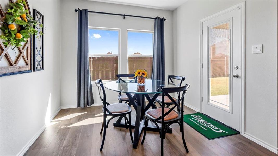 Dining room featuring wood finished floors and baseboards