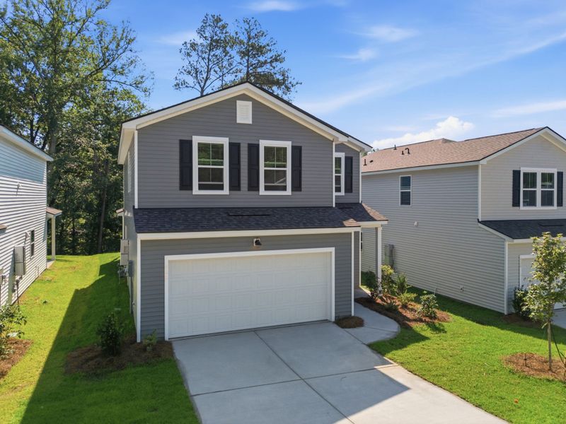 Front exterior of a new home in Grand Arbor, Blythewood, SC, highlighting curb appeal (Image 1). Front exterior of a new home in Grand Arbor, Blythewood, SC, highlighting curb appeal (Image 1).