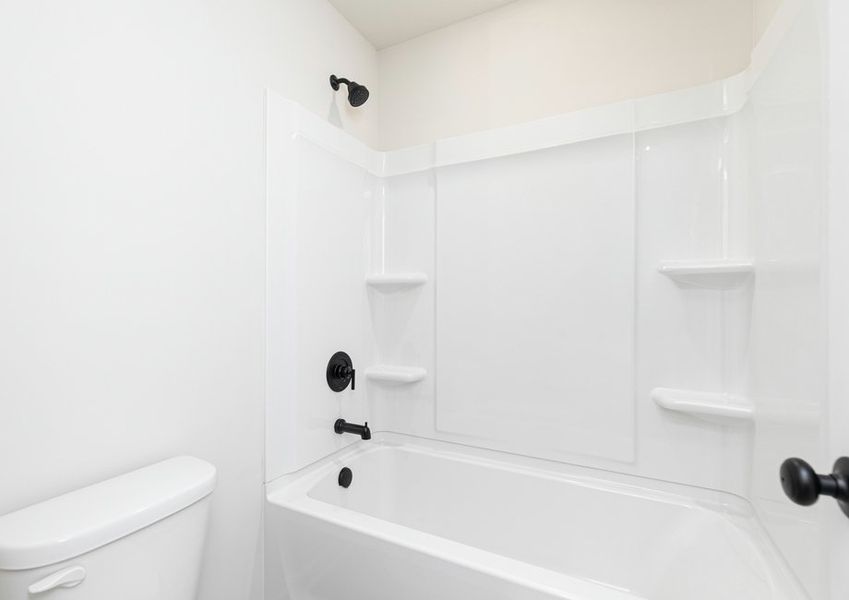 The secondary bathroom includes a dual shower and bathtub