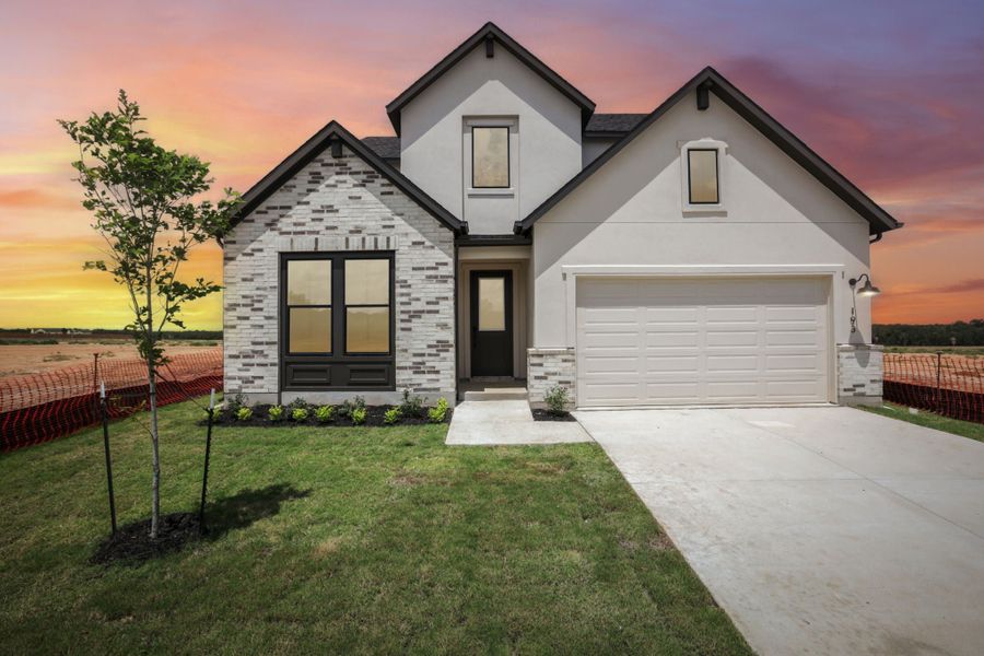 Front exterior of a new home in Freedom at Anthem, Kyle, TX, highlighting curb appeal (Image 1). Front exterior of a new home in Freedom at Anthem, Kyle, TX, highlighting curb appeal (Image 1).