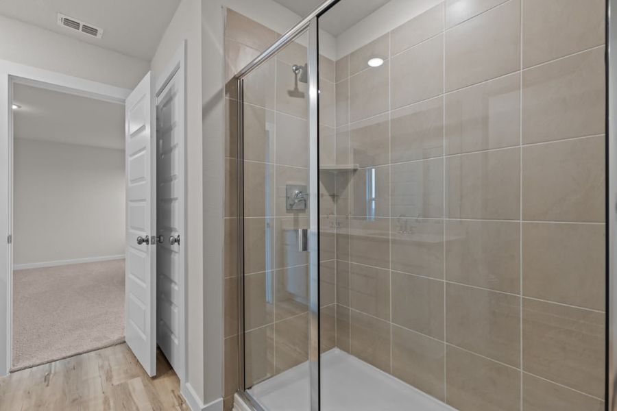 A shower with a glass door. A shower with a glass door.