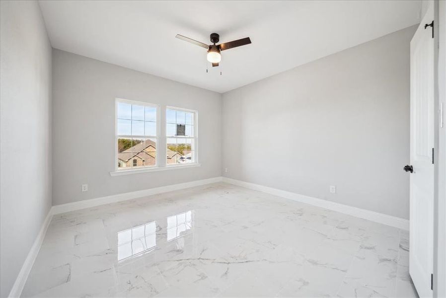 Unfurnished room featuring ceiling fan