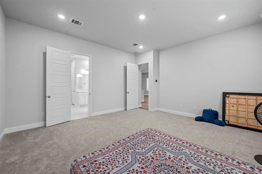 Second primary bedroom featuring carpet, recessed lighting, and ensuite bathroom