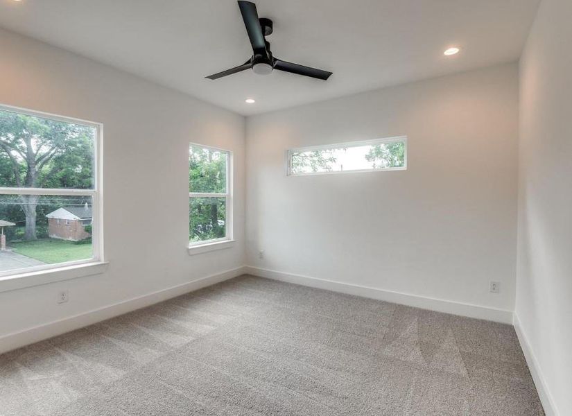 Carpeted empty room with ceiling fan