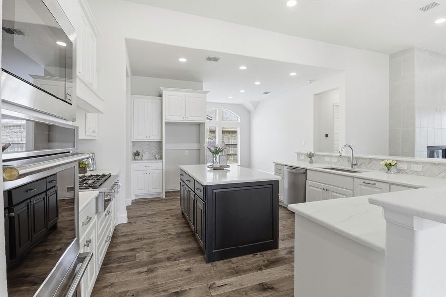 The chef in the family with love this space!  Well thought out kitchen design with island, double oven, microwave, and 6 burner gas stove.