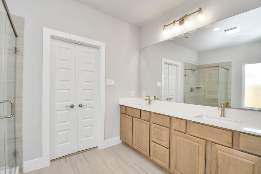 Elevate your daily routine at the elegant vanity, now equipped with double sinks, light countertops, modern hardware, and beautiful vanity lights. Elevate your daily routine at the elegant vanity, now equipped with double sinks, light countertops, modern hardware, and beautiful vanity lights.