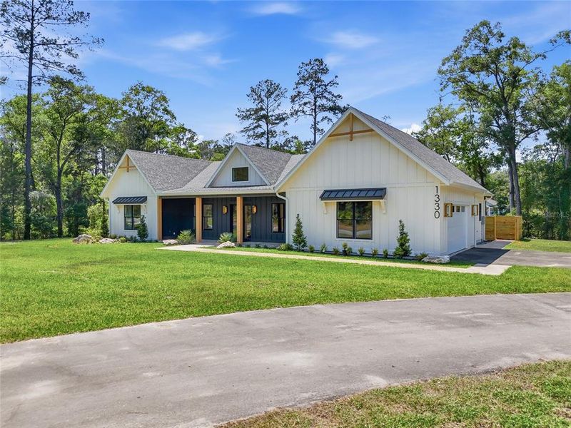 Front exterior of a new home in , Newberry, FL, highlighting curb appeal (Image 27).