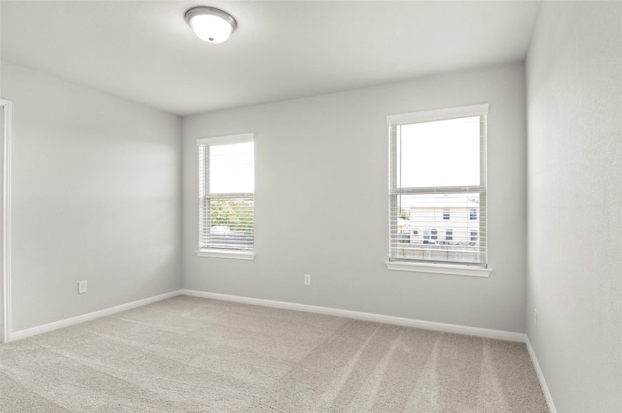 Unfurnished room featuring carpet floors and baseboards