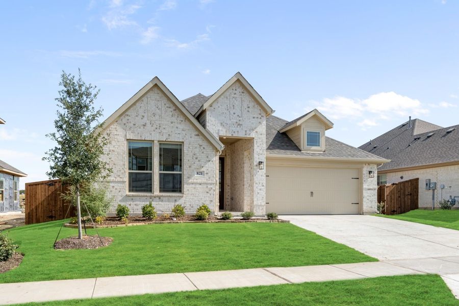 Single-story home with light brick exterior, two-car garage, and manicured front lawn Single-story home with light brick exterior, two-car garage, and manicured front lawn