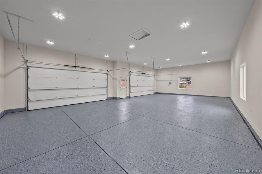 The oversized four-car garage features enough depth for an extended-bed truck - a unique feature to this home!