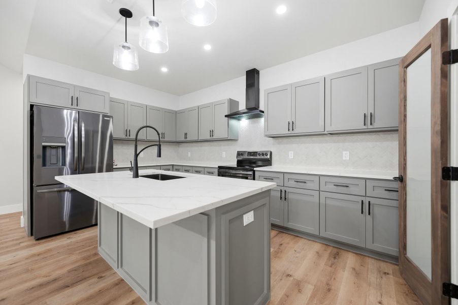 Culinary delights await in this bright kitchen with an inviting island and elegant countertops. Culinary delights await in this bright kitchen with an inviting island and elegant countertops.