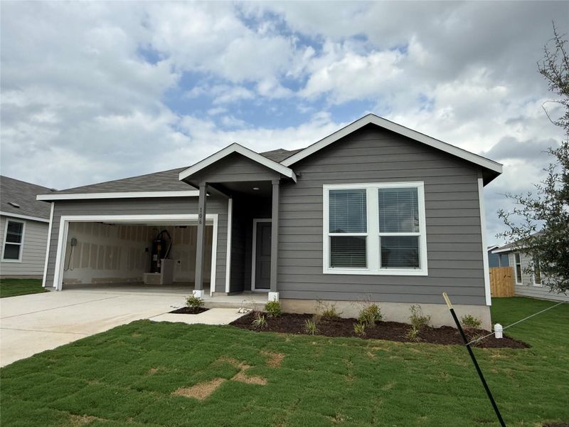 Front exterior of a new home in Bertram Oaks: Classic Collection, Bertram, TX, highlighting curb appeal (Image 2). Front exterior of a new home in Bertram Oaks: Classic Collection, Bertram, TX, highlighting curb appeal (Image 2).