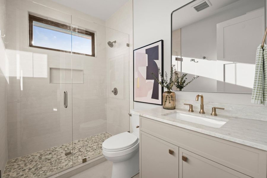 Bathroom featuring a shower stall and vanity