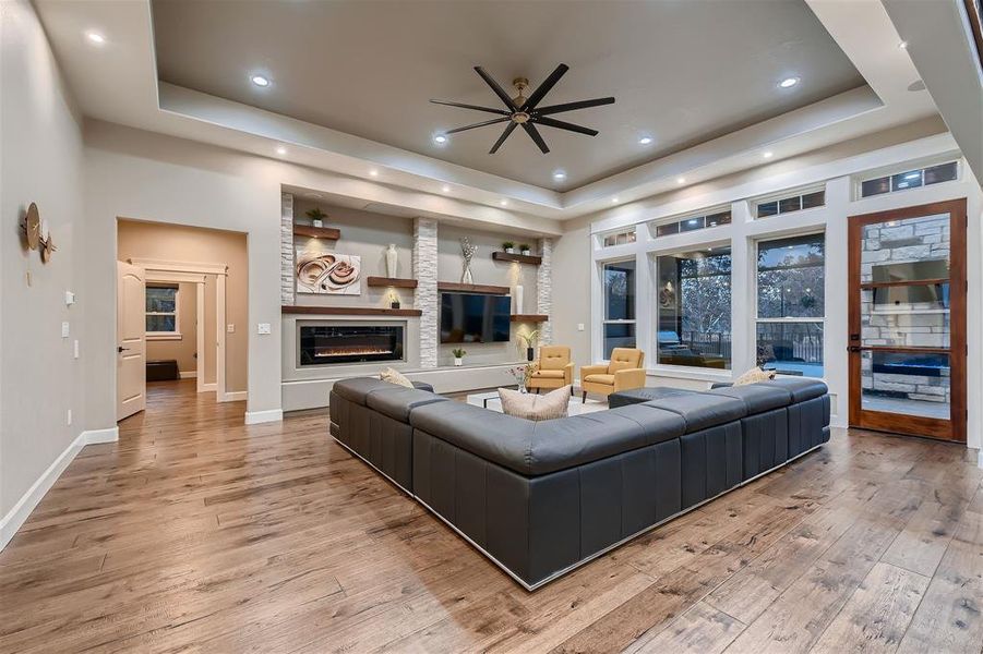 The living room showcases a custom feature-rich wall including an electric fireplace