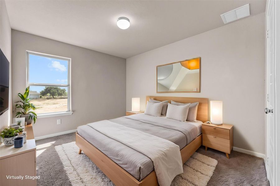 A tranquil bedroom with a warm wooden bed frame and complementary side tables invites peaceful rest.