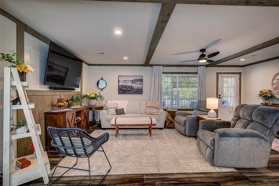 Living area with beamed ceiling, LVP floors, ceiling fan, recessed lighting, and crown molding