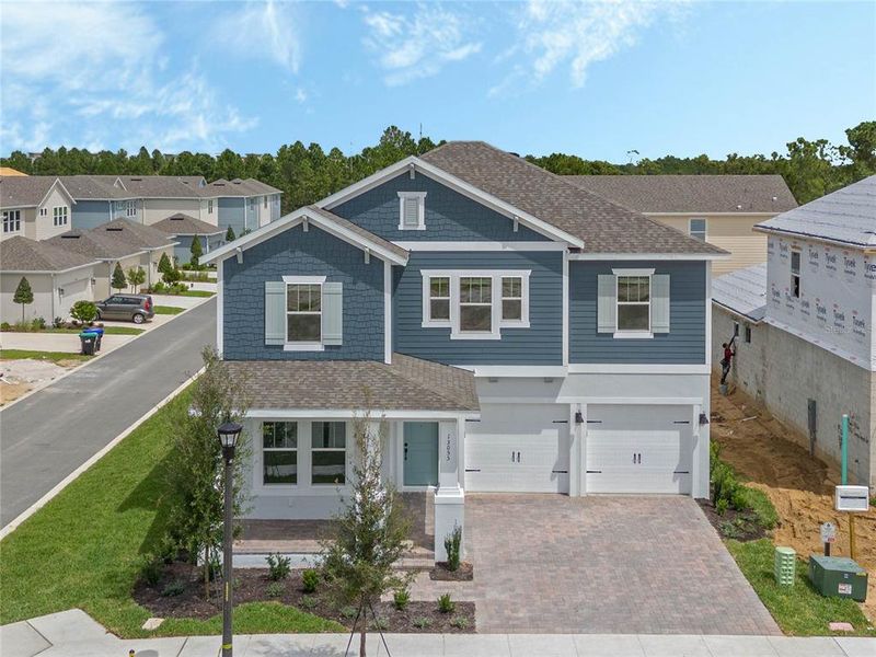 Front exterior of a new home in Northlake At Ovation, Winter Garden, FL, highlighting curb appeal (Image 2). Front exterior of a new home in Northlake At Ovation, Winter Garden, FL, highlighting curb appeal (Image 2).