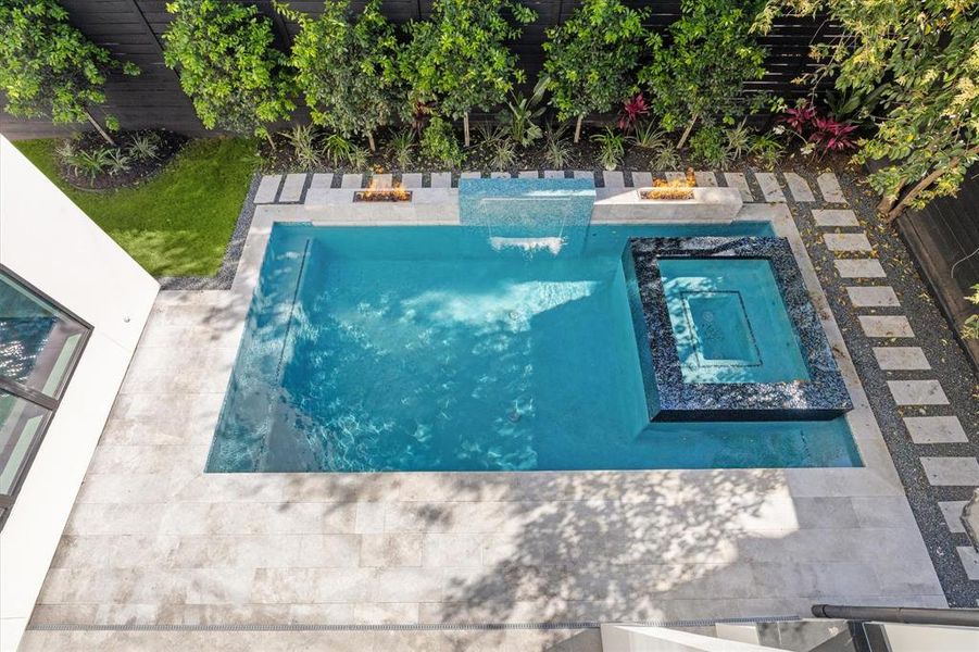 Another view of the in ground pool and spa with water and fire features