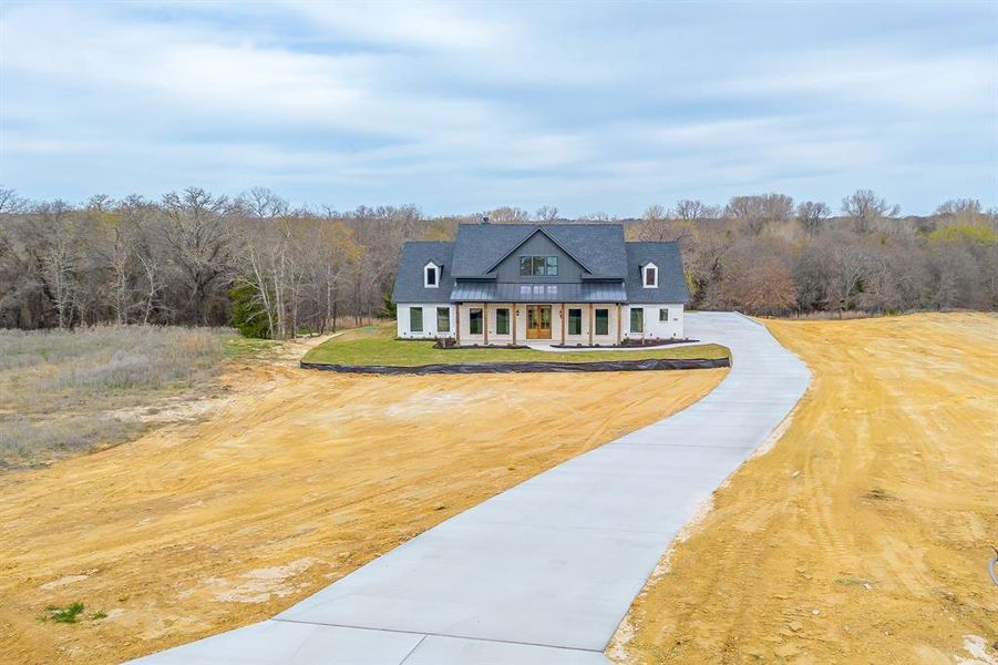 Front exterior of a new home in , Poolville, TX, highlighting curb appeal (Image 28). Front exterior of a new home in , Poolville, TX, highlighting curb appeal (Image 28).