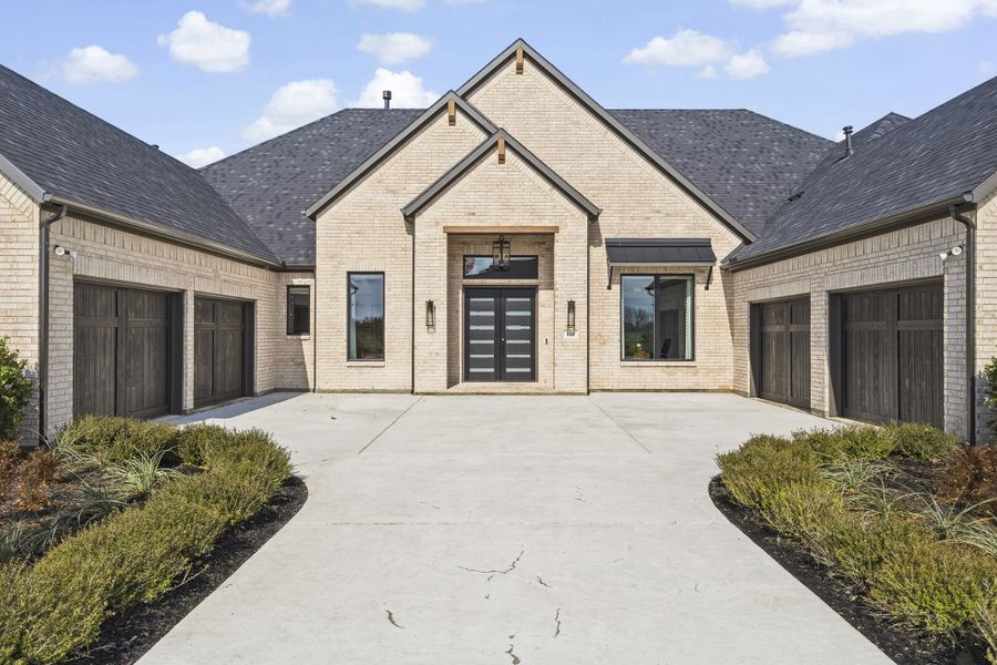 Front exterior of a new home in Ridge Pointe Estates, McLendon-Chisholm, TX, highlighting curb appeal (Image 26). Front exterior of a new home in Ridge Pointe Estates, McLendon-Chisholm, TX, highlighting curb appeal (Image 26).