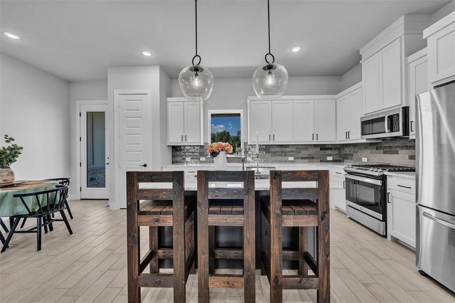 Modern kitchen featuring a central island with pendant lighting