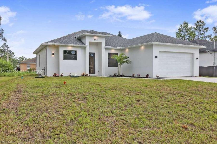 Front exterior of a new home in , Lehigh Acres, FL, highlighting curb appeal (Image 2). Front exterior of a new home in , Lehigh Acres, FL, highlighting curb appeal (Image 2).