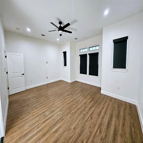 Primary bedroom with electric black shades.