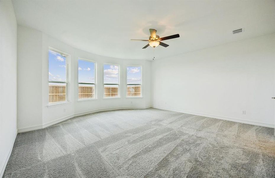 Elegant owner's suite with bay window*real home pictured