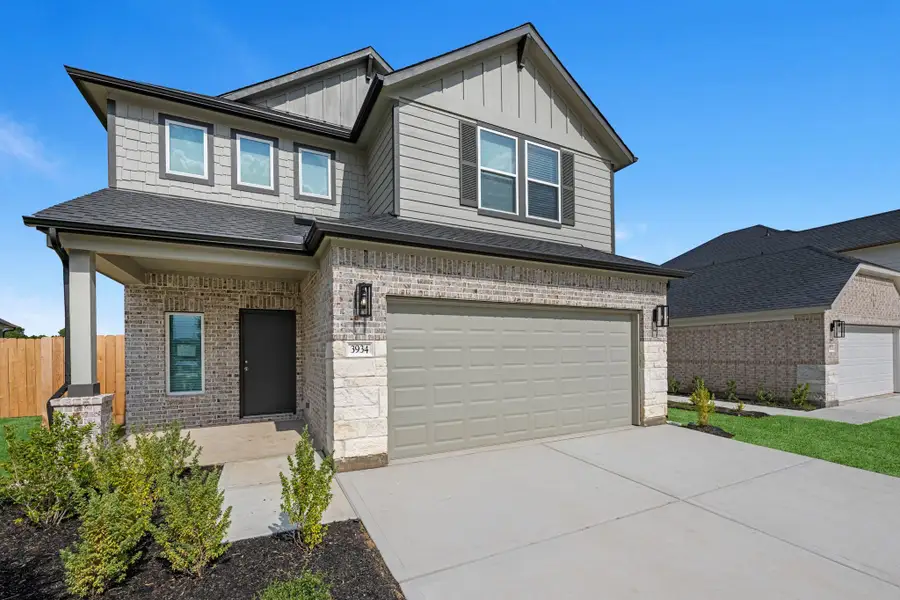 Front exterior of a new home in Grand Oaks Village, Houston, TX, highlighting curb appeal (Image 1). Front exterior of a new home in Grand Oaks Village, Houston, TX, highlighting curb appeal (Image 1).