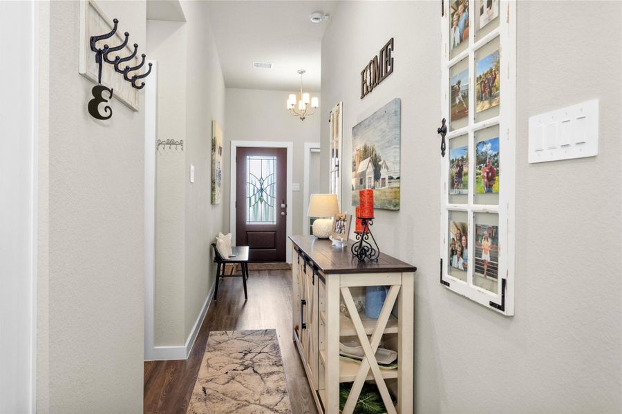A view of the hall that leads from entry to living room. You will notice the opening on your left that is the hall entry to your garage and laundry areas. A view of the hall that leads from entry to living room. You will notice the opening on your left that is the hall entry to your garage and laundry areas.