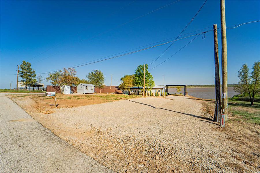 View of yard with driveway and a shed View of yard with driveway and a shed