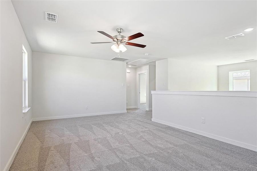 Spare room with ceiling fan and light carpet