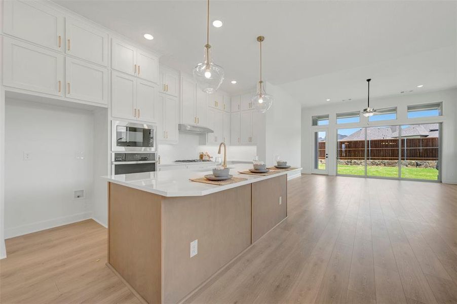 Open-concept living space with light wood-finish flooring
