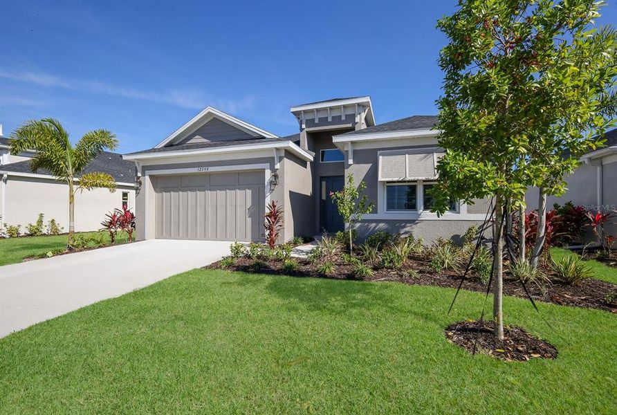 Front exterior of a new home in The Willows, Parrish, FL, highlighting curb appeal (Image 2).