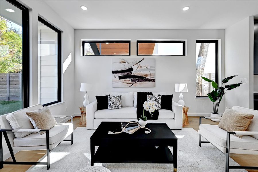 Living room featuring light wood-type flooring and a wealth of natural light