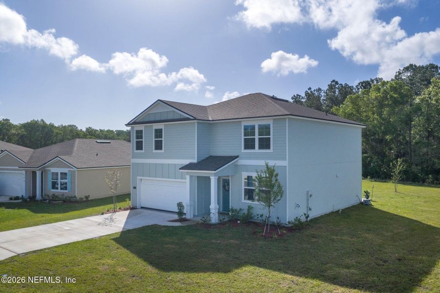 Front exterior of a new home in Entrada, St. Augustine, FL, highlighting curb appeal (Image 22). Front exterior of a new home in Entrada, St. Augustine, FL, highlighting curb appeal (Image 22).