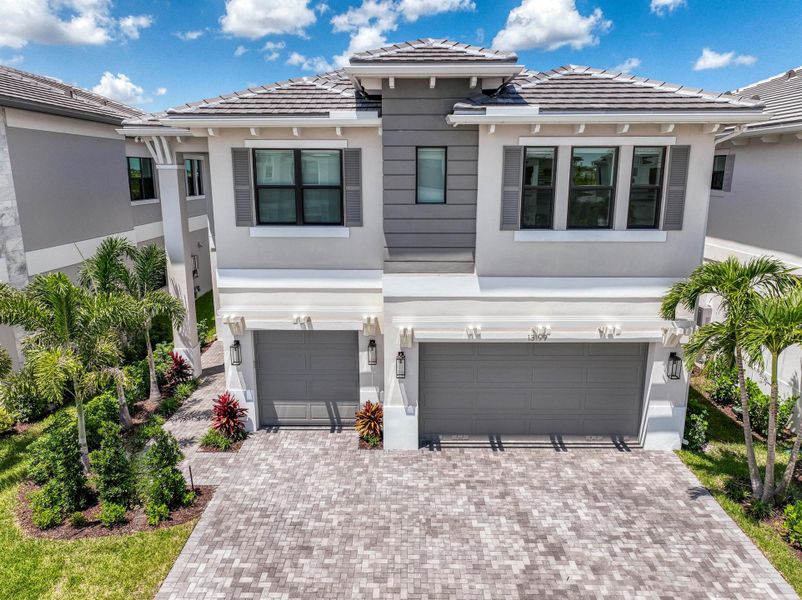 Front exterior of a new home in Apex at Avenir, Palm Beach Gardens, FL, highlighting curb appeal (Image 27). Front exterior of a new home in Apex at Avenir, Palm Beach Gardens, FL, highlighting curb appeal (Image 27).