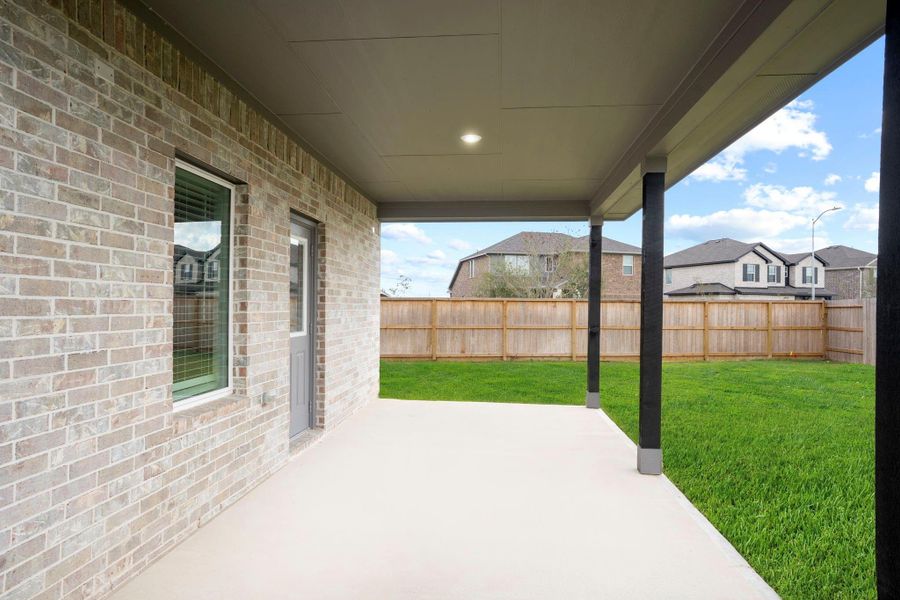 Enjoy relaxing evenings under the spacious covered patio, perfect for outdoor dining, morning coffee, or simply taking in the peaceful backyard views.