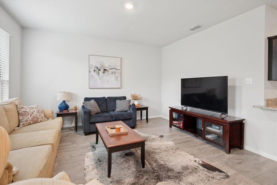 Living area with light wood finished floors and recessed lighting. Living area with light wood finished floors and recessed lighting.