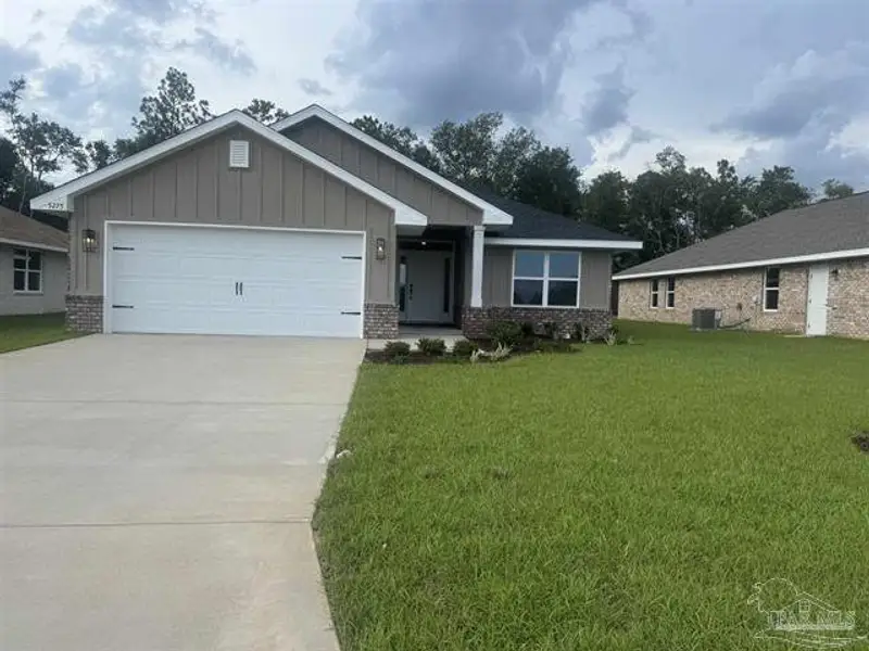 Front exterior of a new home in Hidden Pines, Milton, FL, highlighting curb appeal (Image 1). Front exterior of a new home in Hidden Pines, Milton, FL, highlighting curb appeal (Image 1).