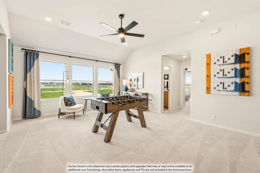 Game room with foosball table, vaulted ceiling, ceiling fan, and large windows with outdoor views